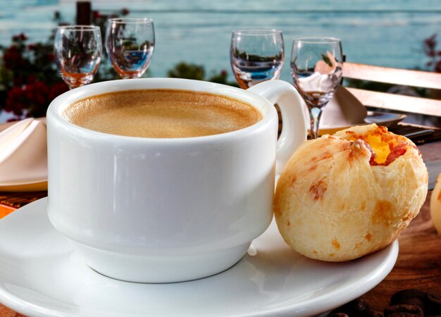 Brazilian snack cheese bread, pao de queijo, Brazilian snack cheese bread stuffed with pepperoni and a cup of coffee