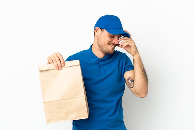 Brazilian taking a bag of takeaway food isolated on white background laughing