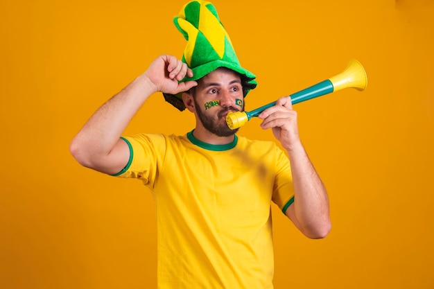 Brazilian with a mini vuvuzela or soccer fan