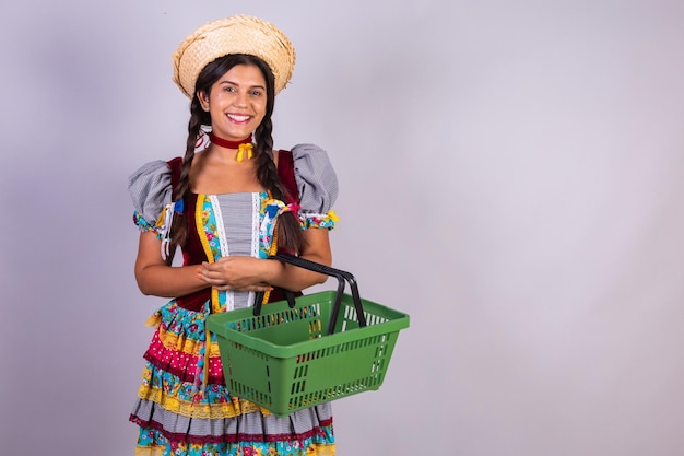 Brazilian woman clothes from Festa Junina Arraial Festa de Sao Joao Using shopping basket Supermarket