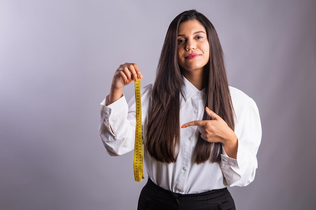 Brazilian woman nutritionist holding measuring tape Horizontal photo