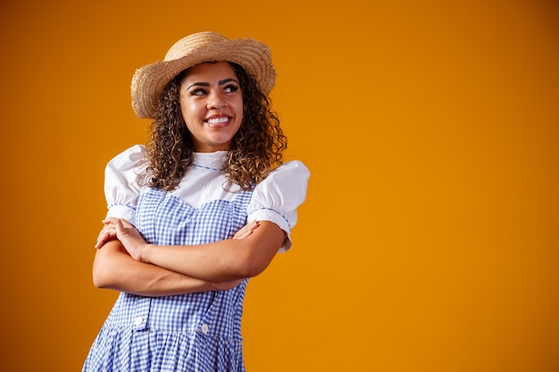 Brazilian woman wearing typical clothes for the Festa Junina with cross arms