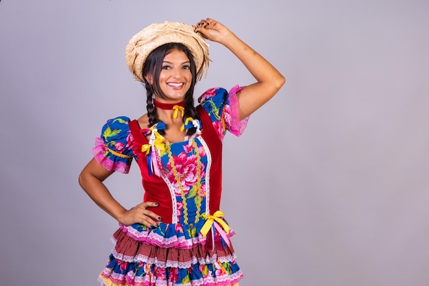 Brazilian woman with clothes from festa de sao joao festa junina horizontal photo posing for the photo