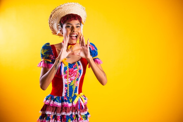 Brazilian woman with festa junina clothes Arraial Feast of Saint John shouting promotion