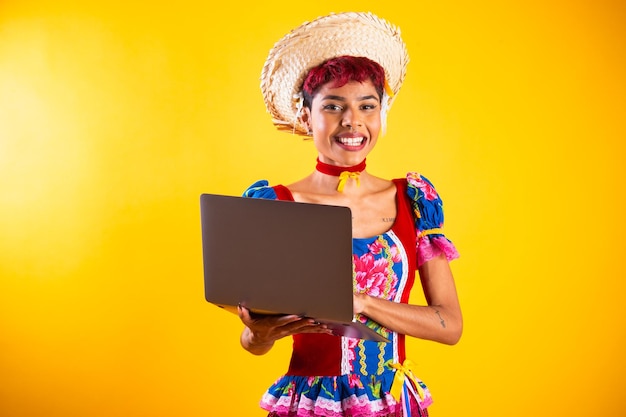 Brazilian woman with festa junina clothes Arraial Feast of Saint John with notebook