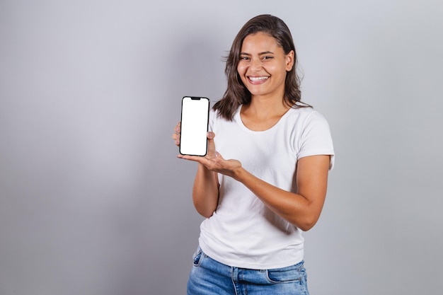 Brazilian woman with smartphone showing white screen for ads and advertisements