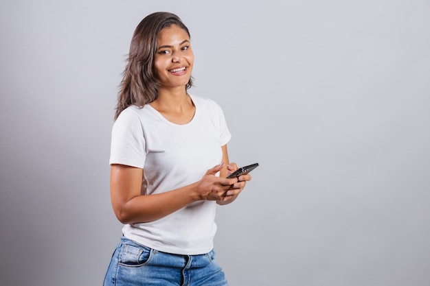 Brazilian woman with smartphone using her cell phone