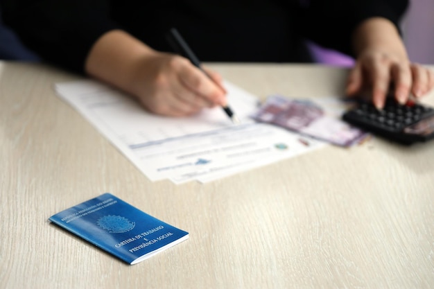 brazilian work card and social security blue book lies on accountant or boss table