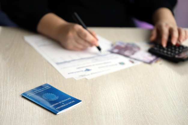 Photo brazilian work card and social security blue book lies on accountant or boss table