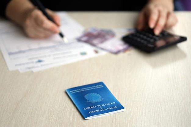 Photo brazilian work card and social security blue book lies on accountant or boss table