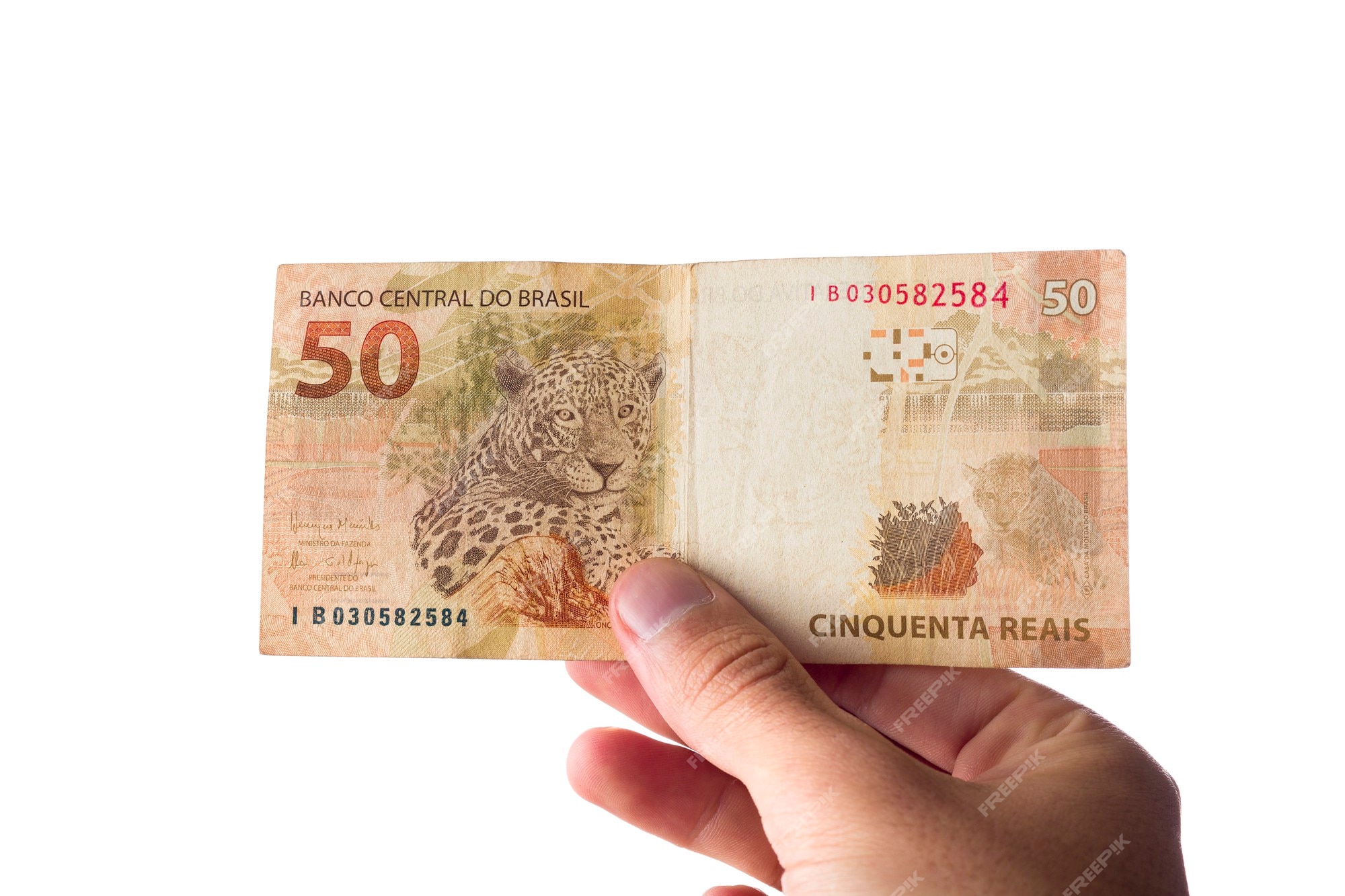 Premium Photo  Brazillian money, man holding 50 reais notes