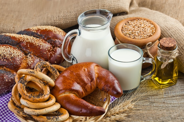 Bread and bagels with jug of milk