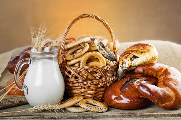 Bread and bagels with jug of milk