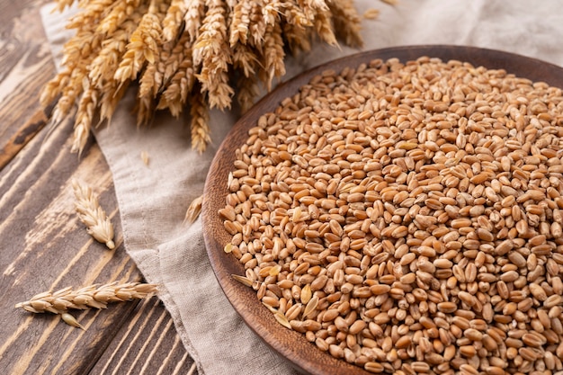 Bread baking background Grain and ears scattered around on rustic wood bread making composition