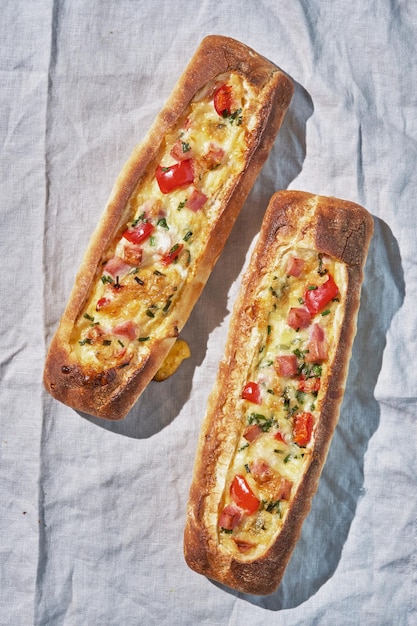 Bread boats stuffed with ham egg and cheese for breakfast