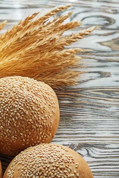 Bread bunch of rye ears on vintage wooden surface