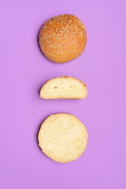 Bread buns isolated on a purple color top view of homemade burger buns