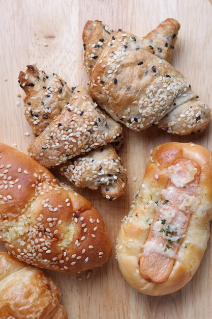 Bread and croissants on wooden board