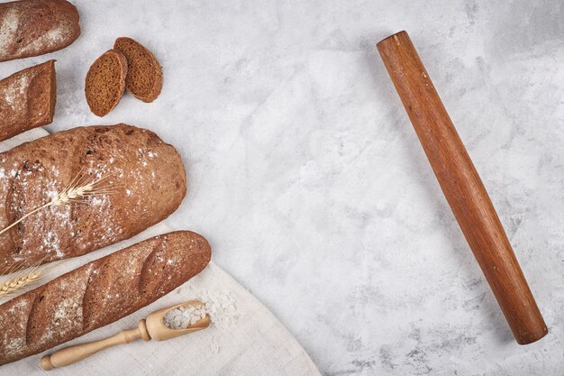 Bread of different varieties on a wood background with copy space background. concept of bakery, cooking and grocery store.