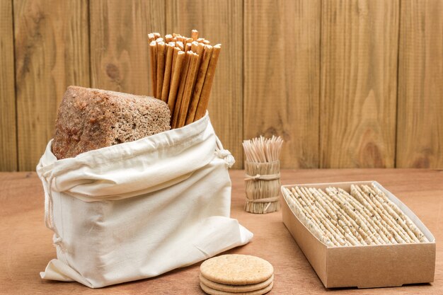 Bread and edible straw in linen bag and Bread in cardboard box.