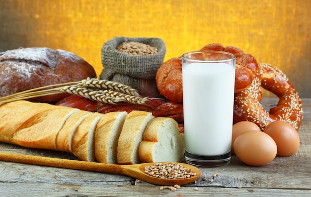 Bread and glass of milk on a wooden background