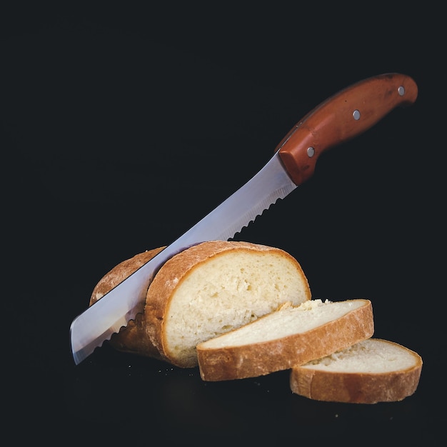 Bread knife cut fresh crispy rye bread Slicing delicious bread