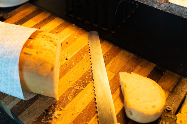 Bread knife with sliced bread, focus on knife