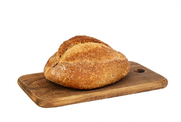 Bread loaf on a wooden chopping board isolated