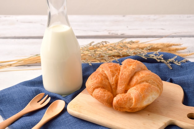 Bread and milk for breakfast on wooden background