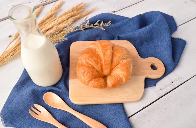 Bread and milk for breakfast on wooden background