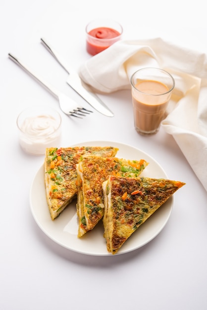 Bread Omelette is a quick and easy breakfast from India. Fresh bread slices dipped into egg batter with spices and shallow fried. served with tomato ketchup and tea