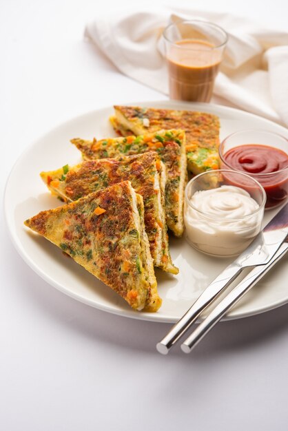 Bread Omelette is a quick and easy breakfast from India. Fresh bread slices dipped into egg batter with spices and shallow fried. served with tomato ketchup and tea