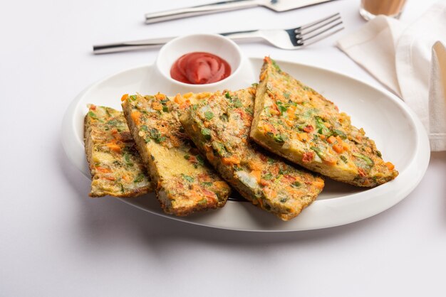 Bread Omelette is a quick and easy breakfast from India. Fresh bread slices dipped into egg batter with spices and shallow fried. served with tomato ketchup and tea