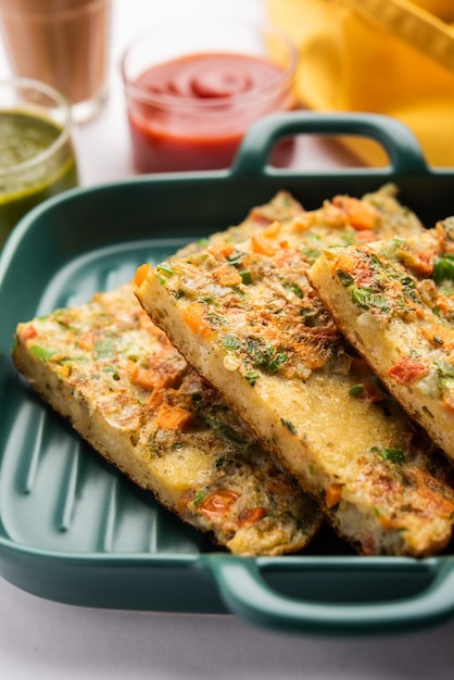 Bread Omelette is a quick and easy breakfast from India. Fresh bread slices dipped into egg batter with spices and shallow fried. served with tomato ketchup and tea