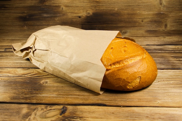 Photo bread packed in paper on wooden table