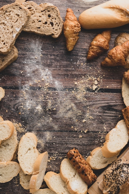 Polvere della pasticceria e del pane su un fondo di legno della tavola