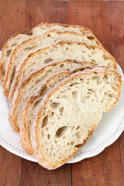 Bread on plate on brown background