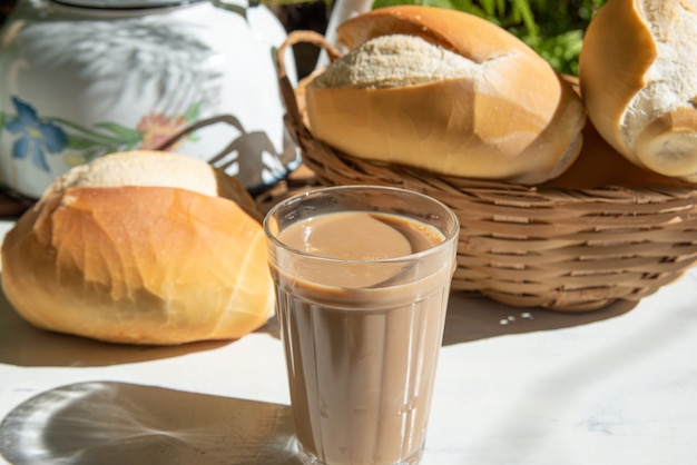 bread, a pot of coffee in an american cup of milk