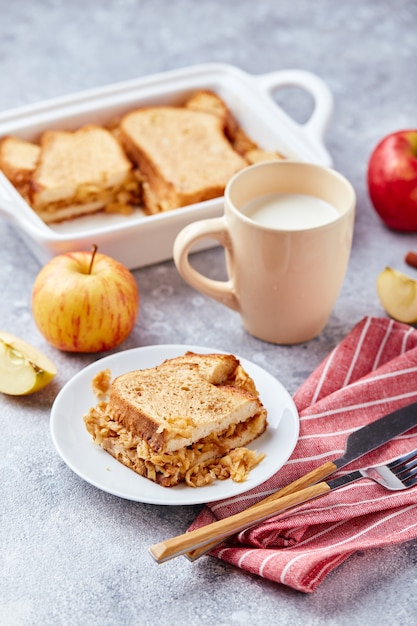 Bread pudding breakfast casserole made from wheat bread eggs milk and grated apples