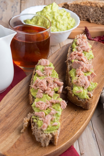 Photo bread of rye with guacamole and tea rooibos