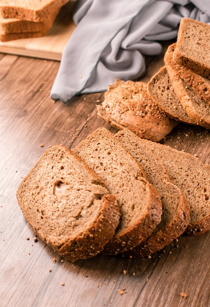 Bread slices pile isolated on wooden table