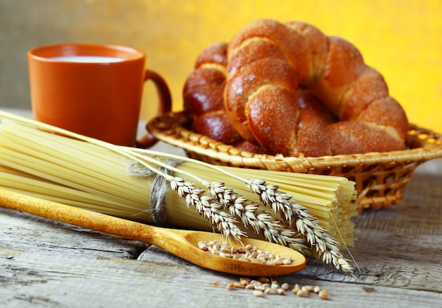 Bread and spaghetti on a wooden board