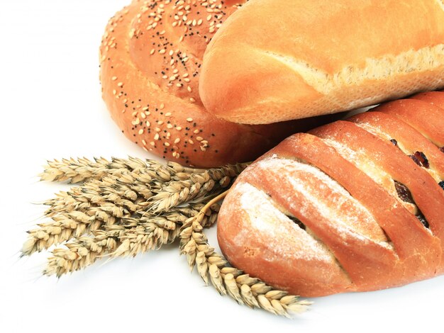 Bread and spikelets of wheat on a white background