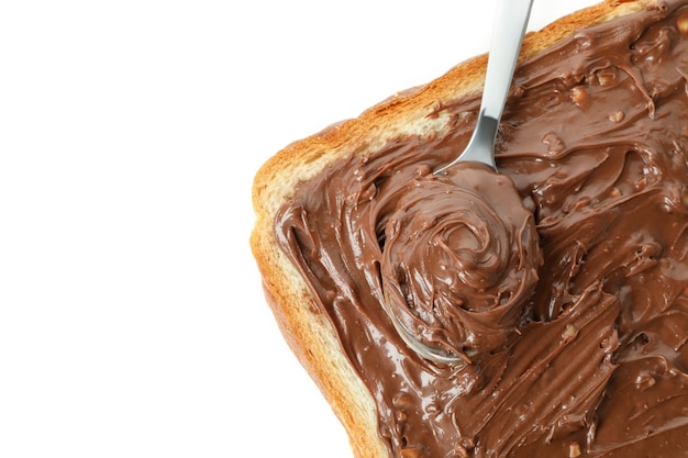 Bread and spoon with chocolate paste isolated on white background