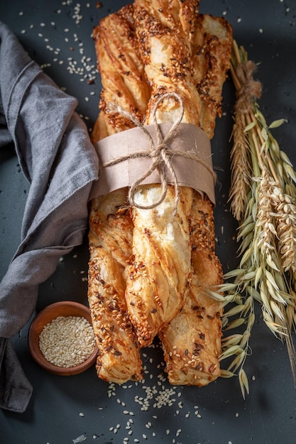 Bread sticks baked in rustic kitchen with ears of grain
