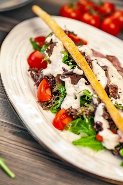 bread sticks with a salad of veggies and sauce