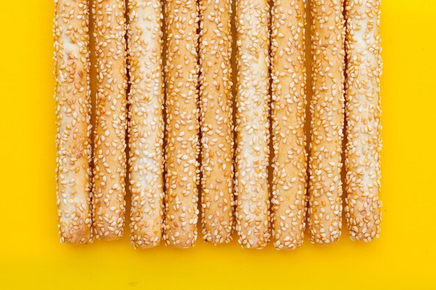 Bread sticks on yellow background