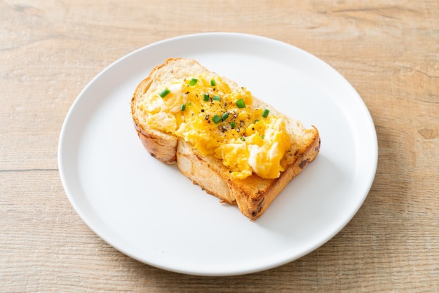 bread toast with scramble egg on white plate