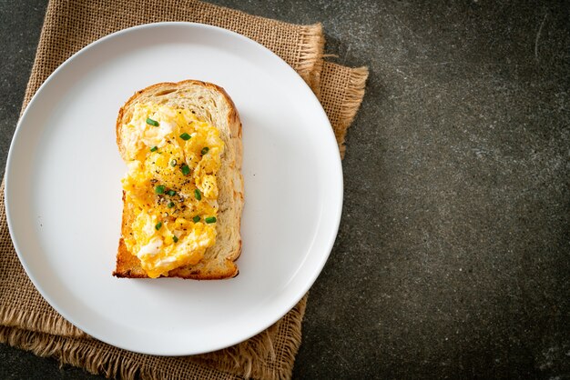 bread toast with scramble egg on white plate