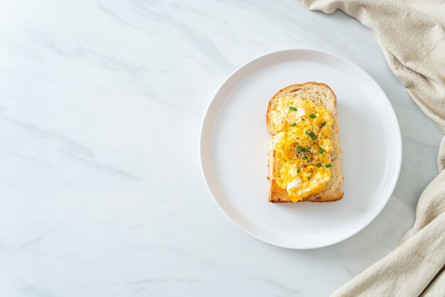 bread toast with scramble egg on white plate